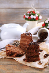 Slices of tasty chocolate cake on plate on table close up
