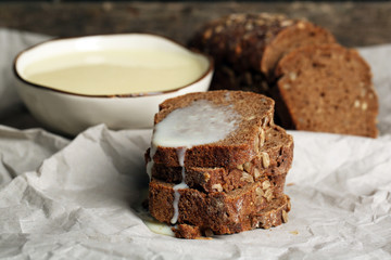 Slices of bread with condensed milk on paper background