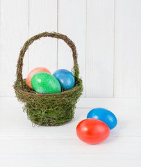 Colorful Easter eggs in green basket