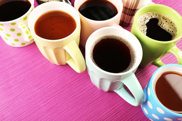 Many cups of coffee on color background