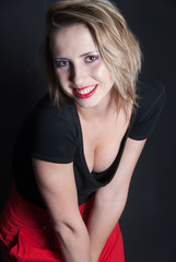 Red skirt and black blouse in studio
