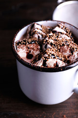 Mug of cocoa with marshmallows on wooden table, closeup
