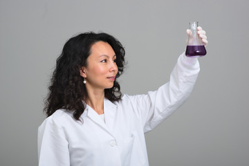 Asian female scientist holding flask