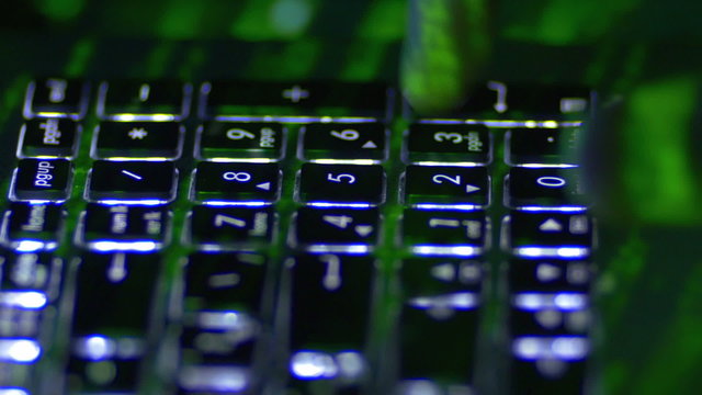 The man work with the laptop backlight keyboard