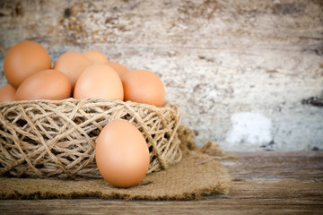 chicken egg in nest on wood background
