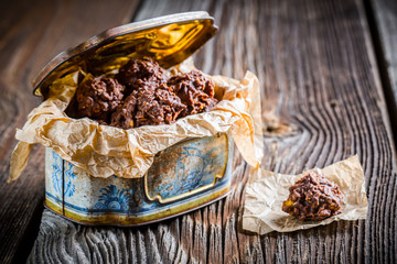 Sweet cocoa balls with corn flakes and milk in old box