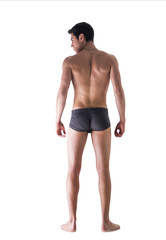 Full body of fit young man seen from the back in underwear isola