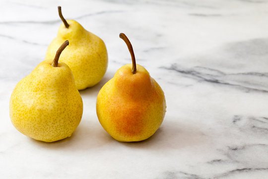 Yellow pears on white marble kitchen counter