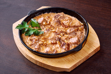 Appetizing meat baked with cheese and walnuts