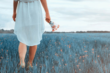 Woman with bouquet of wildflowers