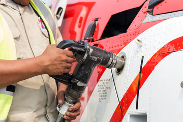 The helicopter is refueling on the helideck