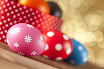Colored Easter eggs on gold background
