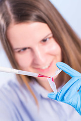 technician in the laboratory with a pipette and test tube