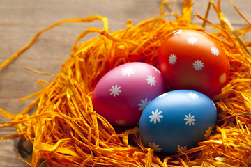 Fototapeta na wymiar Colored Easter eggs in the nest