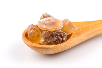 brown caramelized sugar in a wooden spoon