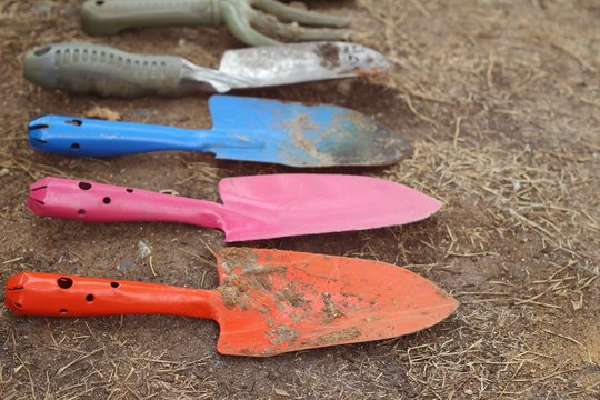 Shovel and fork for gardening on soil background