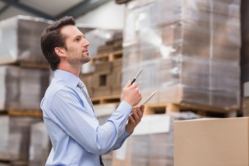 Warehouse manager checking his inventory