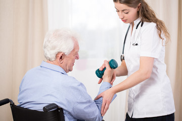 Practitioner showing patient exercise