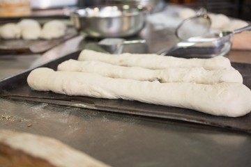 Worktop with dough and bread uncooked