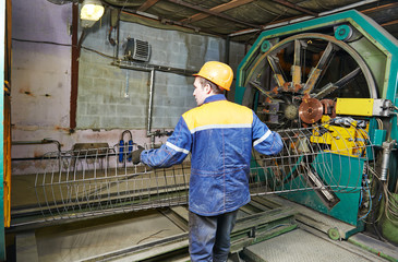 worker making reinforcement for pipe