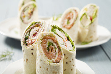 Mix of wraps with ham, chicken, salmon and crab served - obrazy, fototapety, plakaty