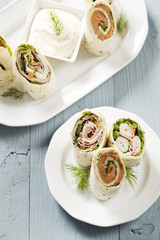 Mix of wraps with ham, chicken, salmon and crab served
