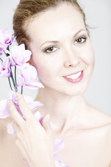 Fototapeta premium Woman holding up Orchids