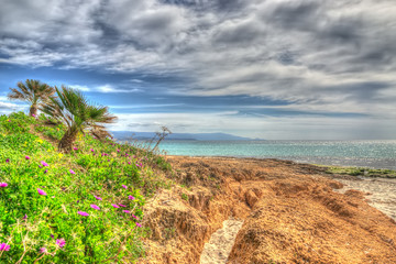 orange rocks in Le Bombarde beach in hdr