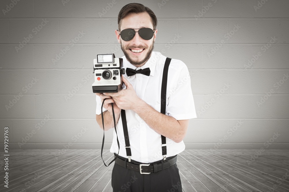 Aufkleber Composite image of geeky hipster holding a retro camera