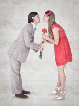 Composite image of cute geeky couple kissing