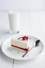 White cheesecake with red berries on a wooden table. Still life