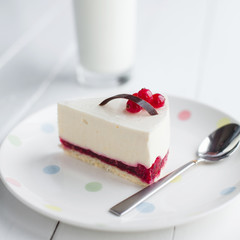 White cheesecake with red berries on a wooden table. Still life