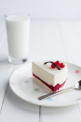 White cheesecake with red berries on a wooden table. Still life