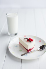 White cheesecake with red berries on a wooden table. Still life