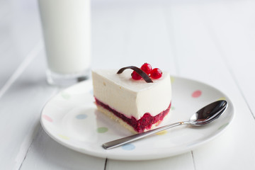 White cheesecake with red berries on a wooden table. Still life