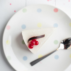 White cheesecake with red berries on a wooden table. Still life