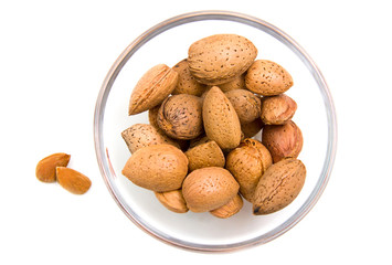 Almonds on bowl on white background viewed from above
