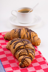 Breakfast with coffee and croissants on table