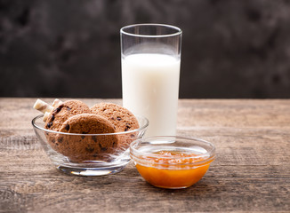 Breakfast with milk and cookies on wooden table