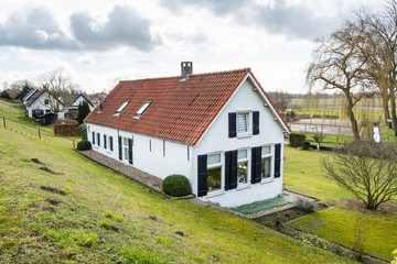 Fototapeta na wymiar Old houses at the bottom of a Dutch dike