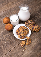 Breakfast with milk and cookies on wooden table
