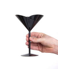 Black plastic coctail glass in hand
