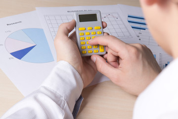 man accounting something with calculator