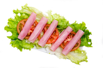 Ham rolled on salad on white background seen from above