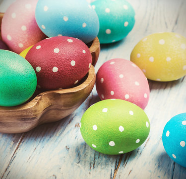 colored Easter eggs on wooden background