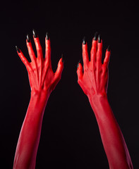 Red devil hands with black nails