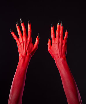 Red devil hands with black nails