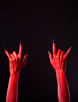 Red spooky hands showing heavy metal gesture