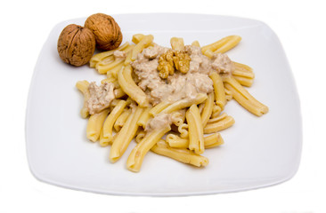 Pasta with walnut pesto on white background