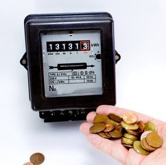 electricity meter with the hand full of European currencies